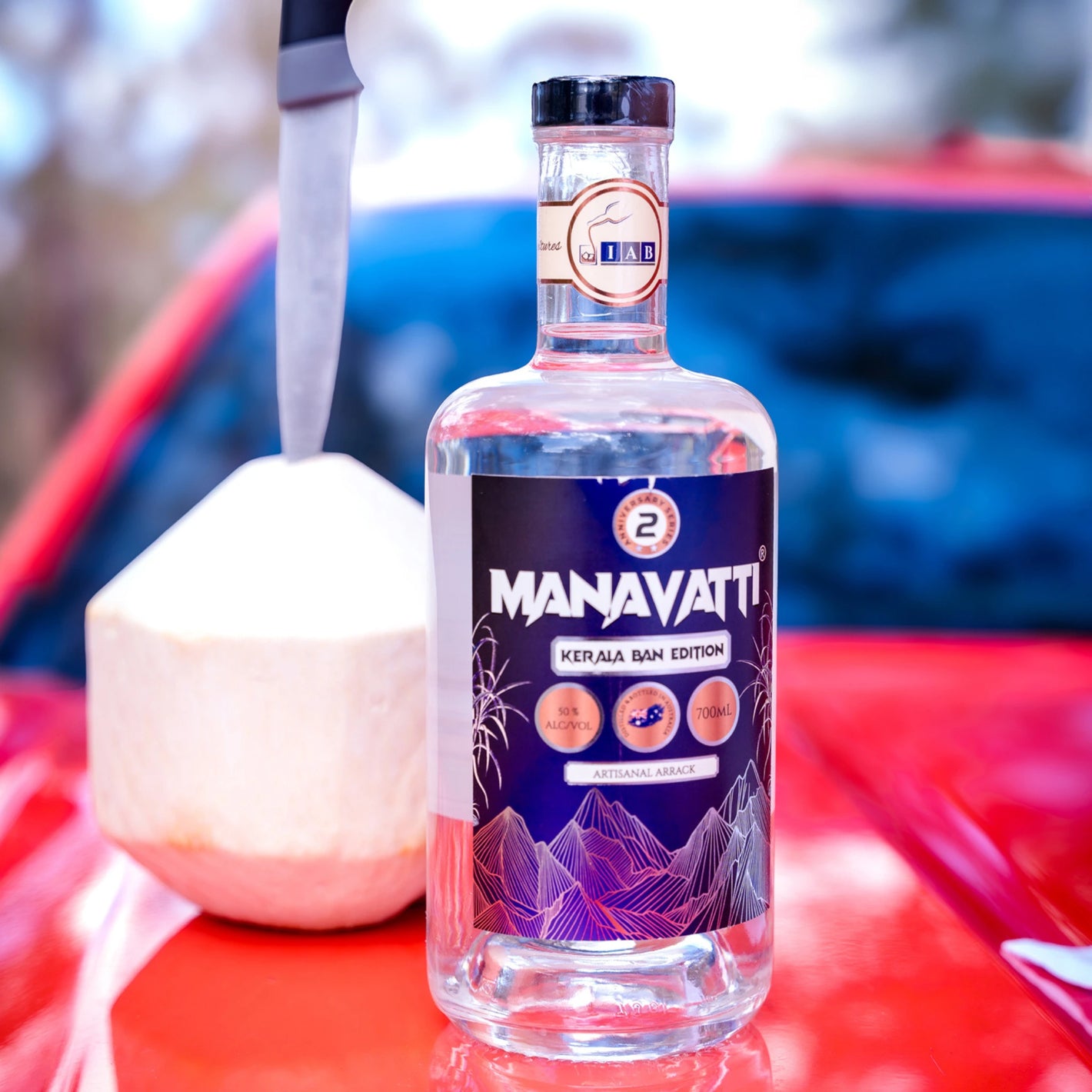 A bottle placed on a car bonnet